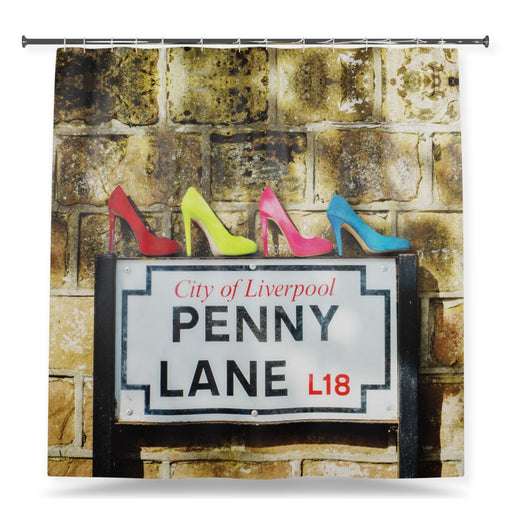 A shower curtain showing an image of a four heel shoes  sat on the famous penny lane sign in liverpool, with a white background