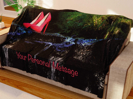 a blanket thrown over a couch, the blanket showing a pair of shoes midway across a flowing river with ta personal message