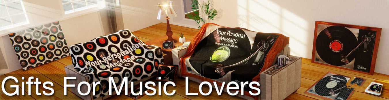 A view of a living room containing multiple music themed soft furnishings including two music themed blankets thrown over two couched and some music themed vinyl record canvas prints laid up against the wall