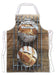 A kitchen apron flat on the floor, the apron having an image of a large sourdough loaf two sourdough loaves seen from aboven