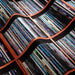 A closeup of a blanket, the blanket having an image of a vinyl record collection on it