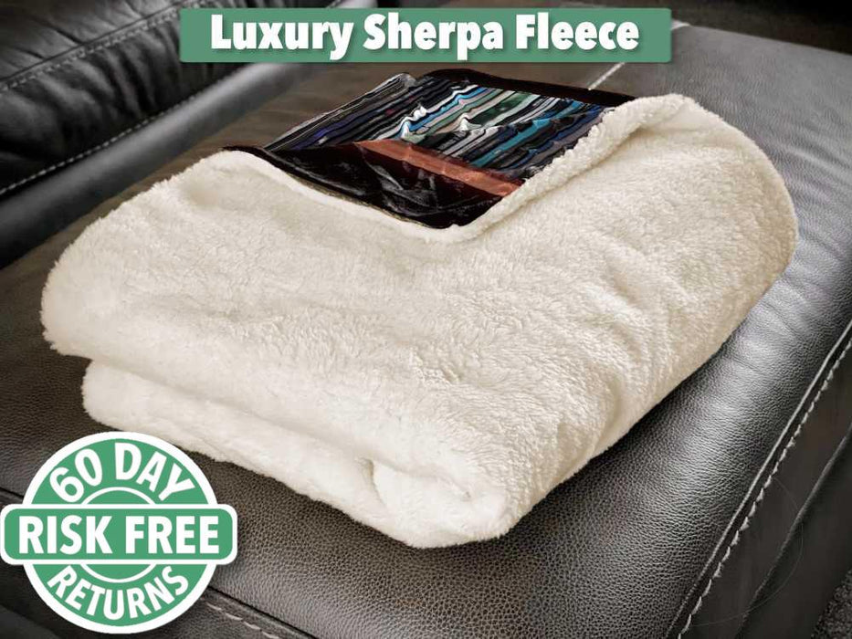 A folded sherpa fleece blanket, mostly showing the white fleece underside, with a folded corner revealing part of an image of vinyl records on a shelf