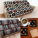 A product bundle of three products. A blanket featuring montage of 7-inch singles, a blanket showing a shelf of vinyl records like a collection and a set of record player coasters