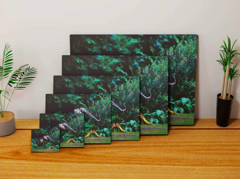 Multiple canvas prints, all of different sizes, each print a pair of yellow high heel shoes in a garden upon the grass, next to the shoes is a metal garden elephant, there are trees in the background