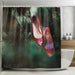 A shower curtain in a bathroom, the curtain having an image of a pair of red high heel shoes hanging of the branch of a tree