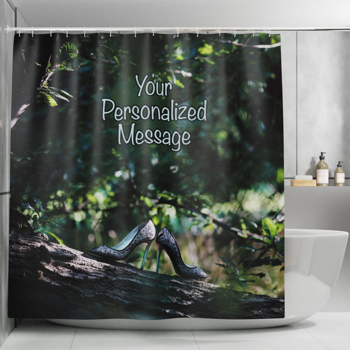 a shower curtain in a bathroom, the curtain showing a pair of high heel shoes resting on a branch of a tree within a forest, along with a personal message printed