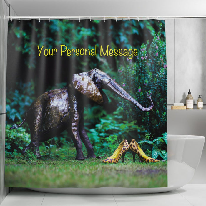 A shower curtain hanging in a bathroom, the curtain having an image of a silver ornament elephant next to a pair of yellow high heel shoes on grass in a garden, along with a printed personal message