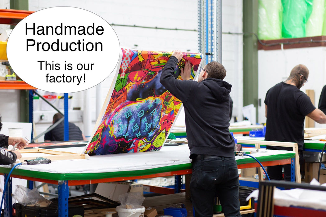 A printing lab with some people producing art work on work benches with tools and wood around them