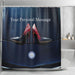 A shower curtain in a bathroom, the shower curtain having an image of a pair of purple and red high heel shoes resting on the bonet of a high performance car, seen from above, along with a printed personal message