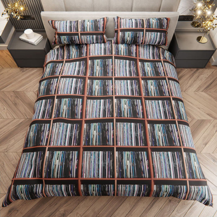 a duvet cover showing an image of a large number of vinyl records stack on display upon a shelf, seen from a point high above the bed