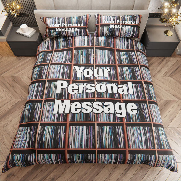 a duvet cover showing an image of a large number of vinyl records stack on display upon a shelf along with a personal message, seen from a point high above the bed