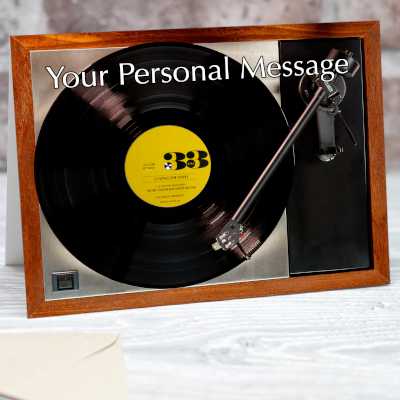 A greeting card with a vinyl record player on it, along with a yellow labelled record playing on the record player, together with a personal message on the card