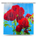 A shower curtain showing an image of red roses, the curtain is pulled open adjacent to a bath