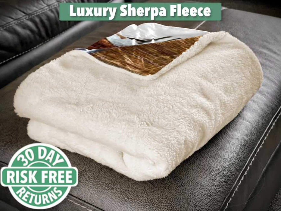 A folded sherpa fleece blanket sat on a couch