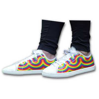 Close up of a pair of white canvas shoes, the shoes having a swirly rainbow pattern on the side