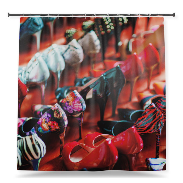 A shower curtain showing an image of a multiple rows of different coloured high heel shoes, with a white background