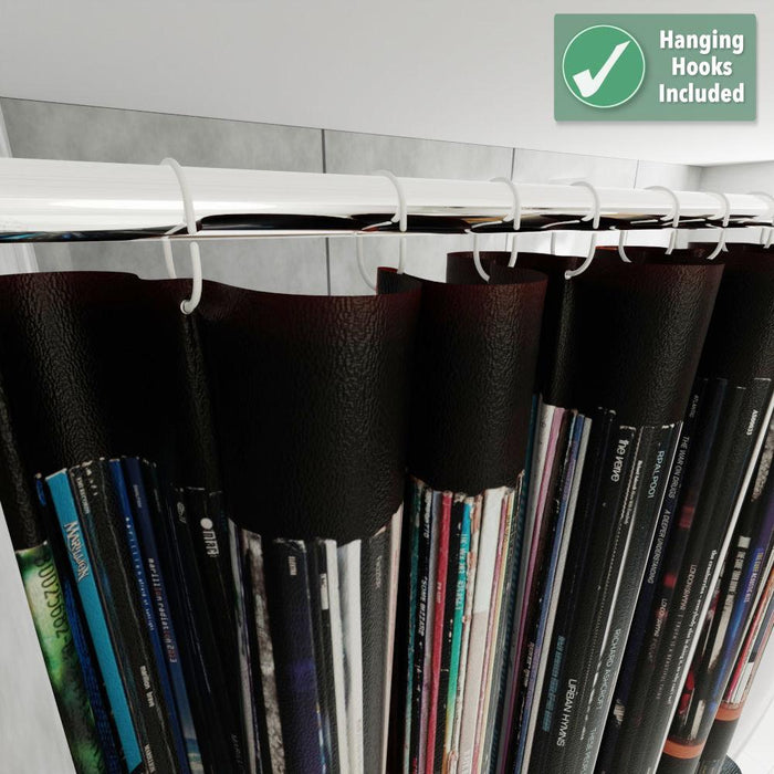 A close up of the top of a shower curtain showing the rings and shower rail, images of vinyl records on a shelf are printed on the curtain with some overlay text