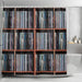 A shower curtain pulled open showing an image of lots of vinyl records stacked along side each other on shelves