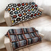Sofa with vinyl record-themed cover and another with a striped pattern on a wooden floor.