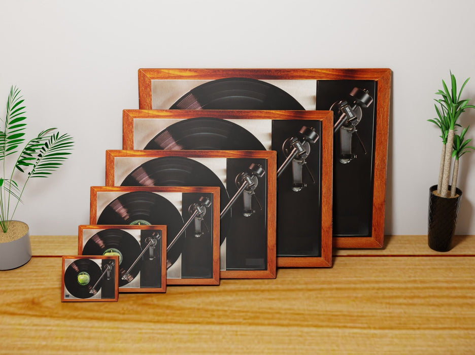 multiple canvas prints all of different sizes resting against each other, leaning against a wall, the canvas prints all show a record player with a record playing