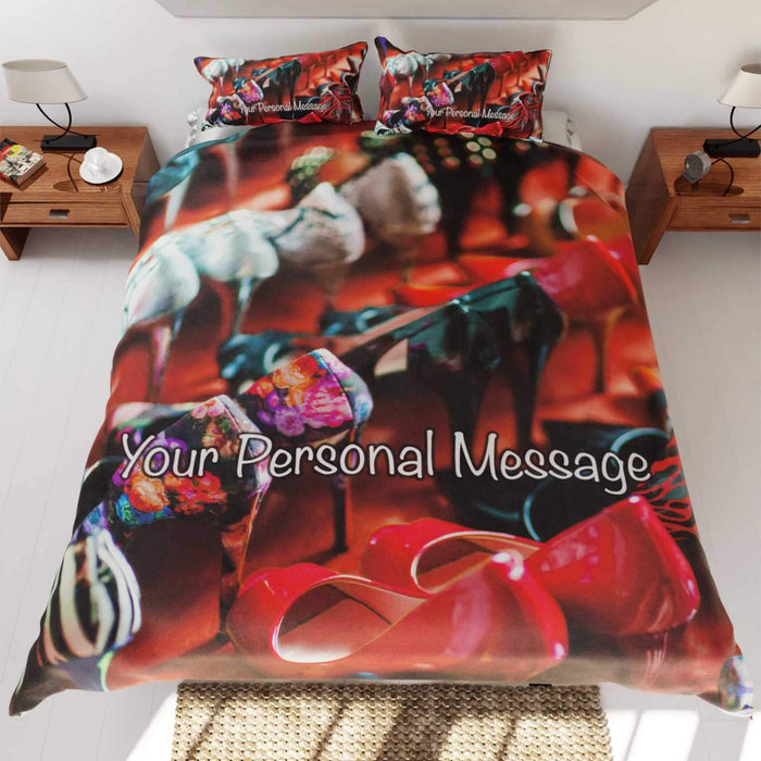 A duvet cover with lots of shoes on it sat on a bed, the duvet and bed seen from above along with a personal message on the duvet