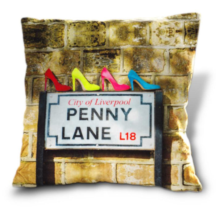 An image of a cushion, the cushion cover showing the famous penny lane road sign in liverpool, and upon that road sign is four high heeled shoes