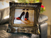 An image of a cushion sat on a couch, the cushion cover showing a mirror with a pair of orage and black high heel shoes reflected in it along with a personal message on the cushion