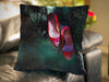 An image of a cushion on a couch, the cushion having a cover showing a pair of pink high heel shoes hanging from a tree
