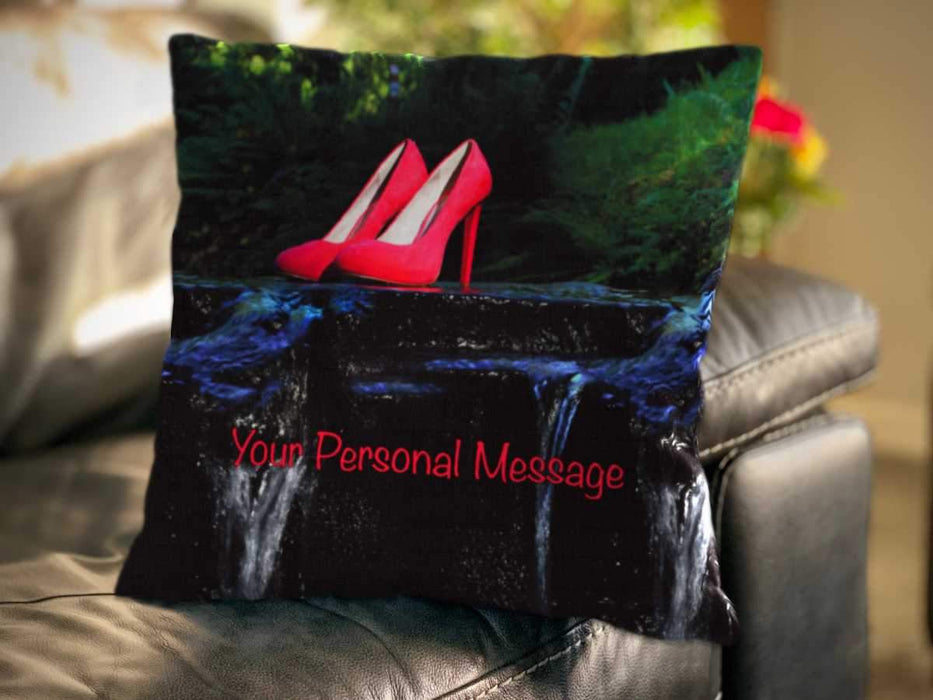 An image of a cushion on a couch, the cushion cover showing an image of a pair of pink high heel shoes sat on a rock in the middle of a flowing river along with a personal message on the cushion