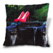 An image of a cushion, the cushion cover showing an image of a pair of pink high heel shoes sat on a rock in the middle of a flowing river