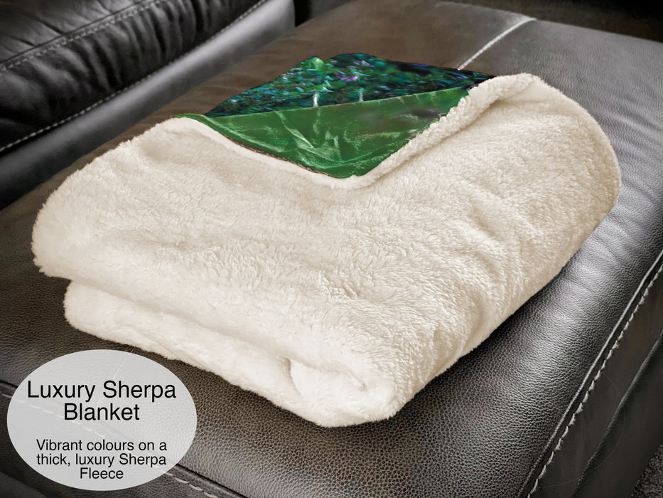 A white sherpa blanket folded up