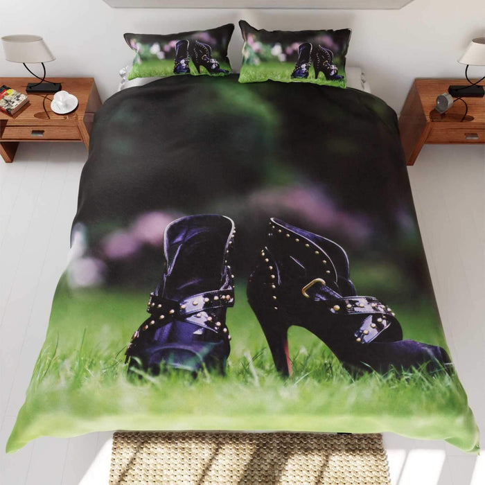 A duvet cover on a bed, the duvet featuring a pair of purple high heel ankle boots stood on a garden