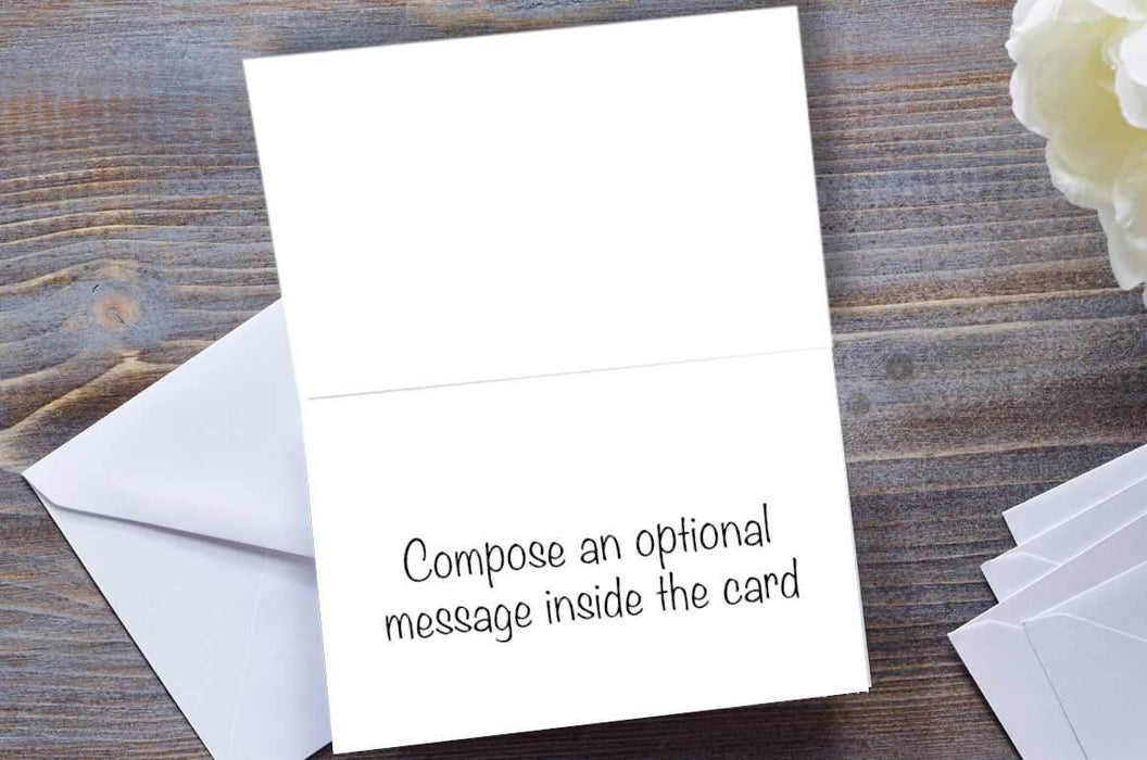 the inside of a greeting card, the card opened, showing a message, the card is on a dark grey table with an envelope in partial view