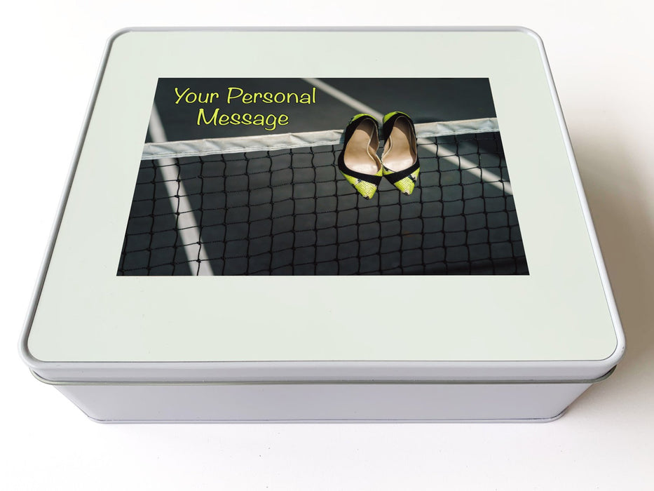 A white tin box with an image of a pair of yellow high heel shoes hung on a tennis net