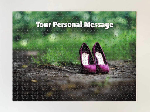 A jigsaw seen from the top, the jigsaw having an image of a pair of purple shoes sitting on a woodland path along with a personal message