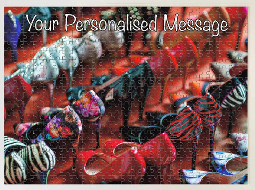 A jigsaw seen from the top, the jigsaw having an image of multiple rows of ladies high heel shoes along with a personal message