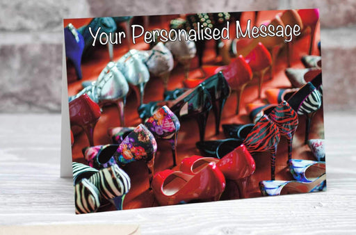 A birthday or greetings card showing large number of high heeled shoes all lined up next to each other along with a personalised message
