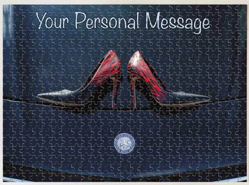 A jigsaw with an image of a pair of blue high heel shoes on the bonnet of a high performance car, along with a printed personal message
