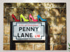 canvas print of famous penny lane street sign with four ladies shoes on top of the sign, the shoes are high heels and coloured in the famous sargent pepper colours of red, yellow, pink and blue