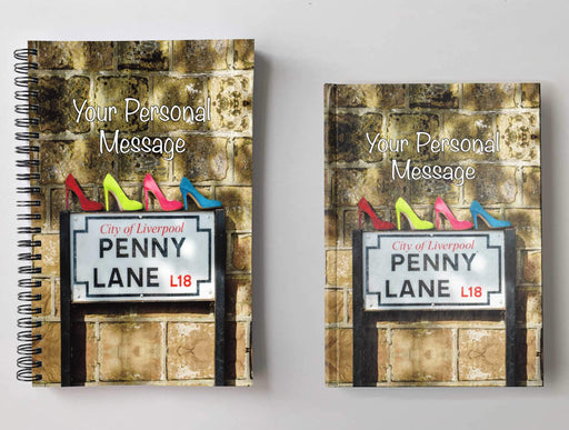 Two notebooks, side by side, both having covers with an image the penny lane road sign in liverpool, with four high heeled shoe sitting on the sign, the shoes coloured red, blue, pink and yellow, and a personal message