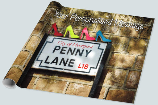 A roll of wrapping paper of four high heeled shoes on top of the penny lane road side made famous by the beetles, the colour of the four shoes being yellow, pink, blue and red along with a personal message