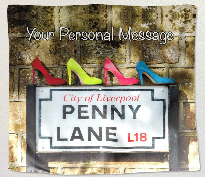 a tapestry fabric hung on a white background the tapestry showing the famous penny lane road sign with four coloured ladies high heel shoes upon it along with a personal message