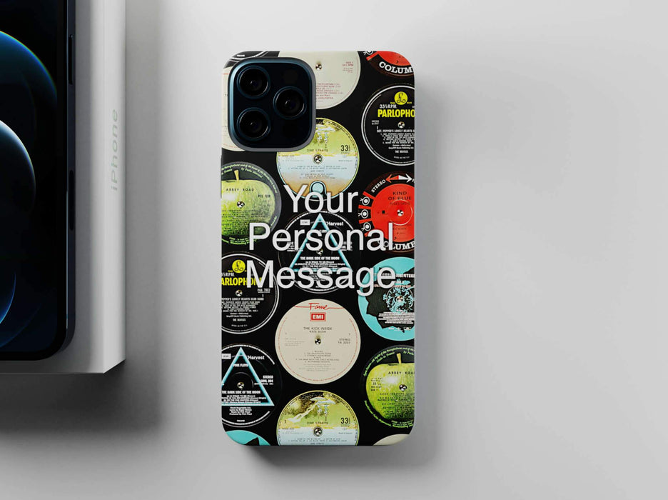 mobile phone cover with vinyl record labels printed in a mosaic pattern, along with a personal message, seen from overhead and sited next to a partially visiable iphone