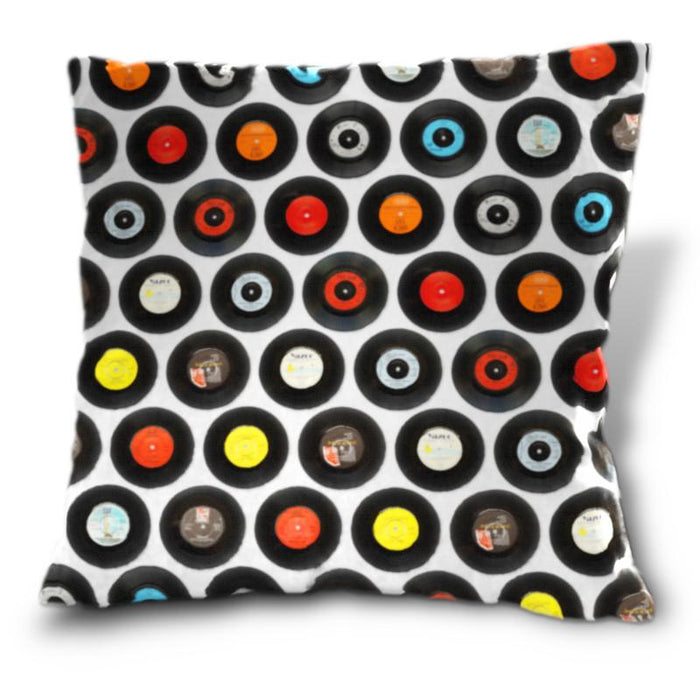 A cushion, the cushion decorated with an image of vinyl records arranged in a mosaic pattern, on a white background