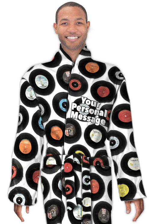 A man wearing a dressing gown, the dressing down is decorated with a montage of vinyl records along with a printed personal message