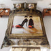 A duvet on a bed seen from above, the duvet having an image of a pair of orange and black shoes seen reflected in a brass mirror