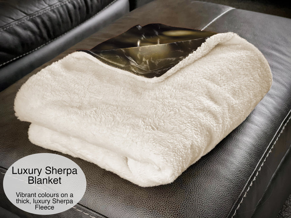 A folded sherpa fleece blanket showing the white underside of the blanket, with a corner folded back