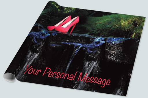 A roll of wrapping paper showing a pair of pink high heel shoes on a rock half way across a flowing river, there is a personal message