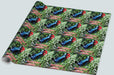 A roll of gift wrapping paper showing a repeated image of pair of blue high heeled shoes n the middle of set of plants in a garden, the plants being mostly green leaves with a large red rose and smaller white flowers