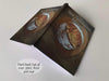 an open hard back notebook, with and image of a large sourdough loaf sat on a heart shaped wooden tray upon a table
